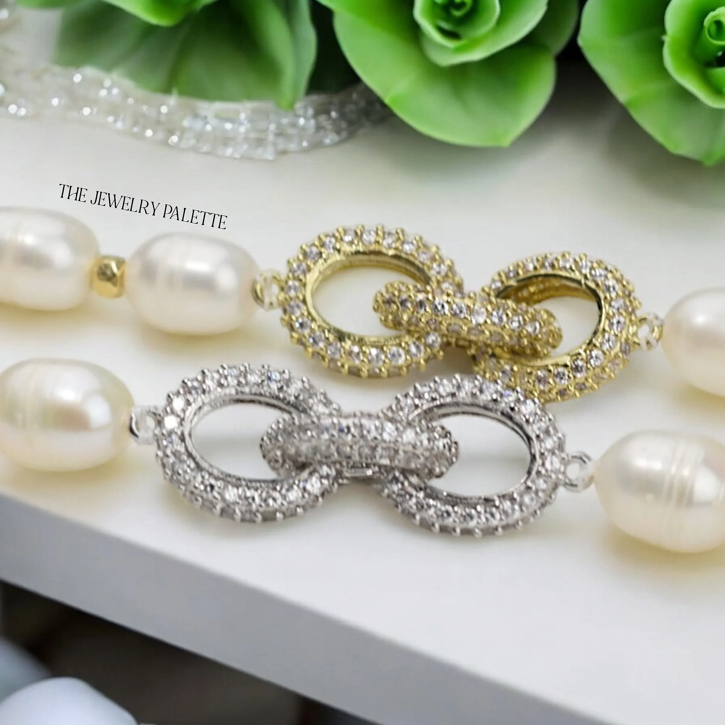 Adele white freshwater pearl bracelet with interlocking gold centerpiece